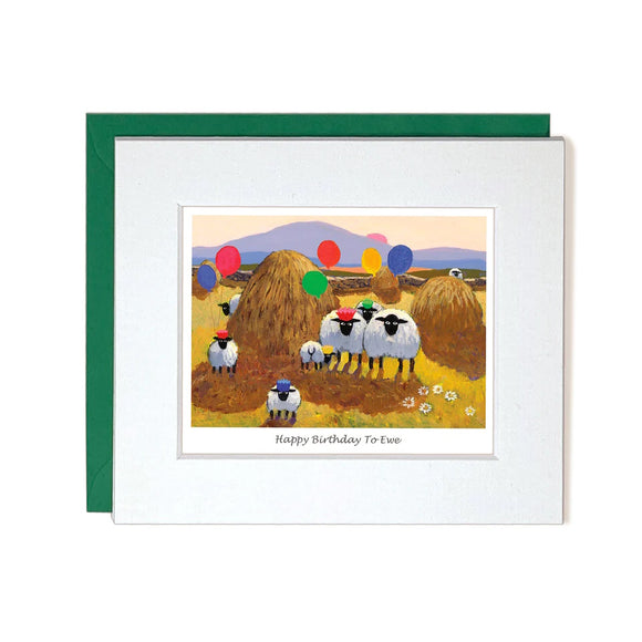 This cute little birthday card by iconic artist Thomas Joseph is decorated with a flock of sheep, standing in a hay field. Some of the sheep are holding colourful balloons and some are wearing paper crowns. The caption on the front of the card reads 