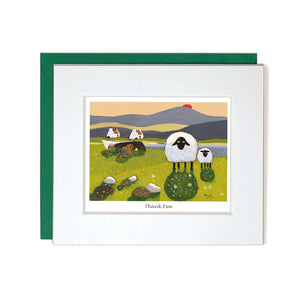 This cute little thankyou card by iconic artist Thomas Joseph is decorated with a pair of sheep, standing in a country landscape - complete with whitewashed cottages, and an upturned boat beside a lake, as the sunsets behind them. The caption on the front of the card reads "Thank Ewe".