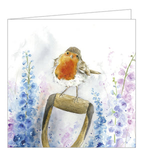 This lovely blank greetings card features artwork by Sarah Reilly showing a cute robin perched on the handle of a spade, with a background of blue, pink and purple flowers.