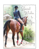 Celebrate her special day with this beautifully illustrated horse riding birthday card from the popular Jonny Javelin collection. Featuring a graceful sketch of a woman on horseback, this elegant design is perfect for horse lovers, equestrians, or anyone who appreciates countryside charm.

The card is finished with delicate silver-foiled text that reads: "Special Wishes to You – Happy Birthday", and includes a stylish scalloped top corner for a premium touch.