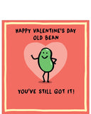 This valentine's card is decorated with a cute illustration of a smiling green bean striking a pose. The text on the front of the card reads "Happy Valentine's Day old bean...you've still got it!"