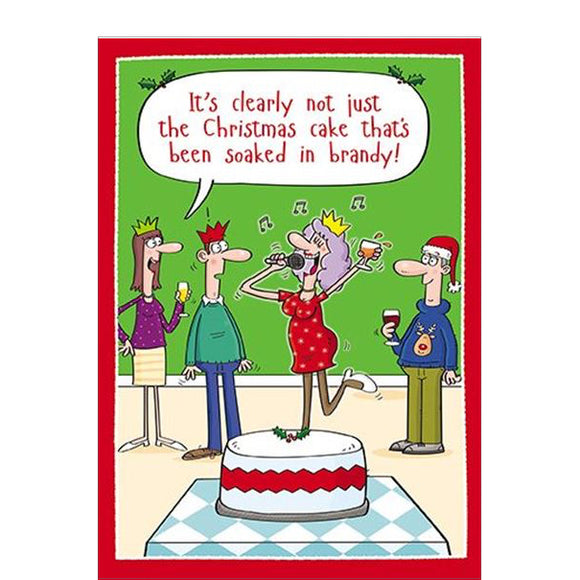 This funny Christmas card features a cartoon showing a christmas party - with a woman holding a glass in one hand and a microphone in the other, performing karaoke. One of the partygoers says 