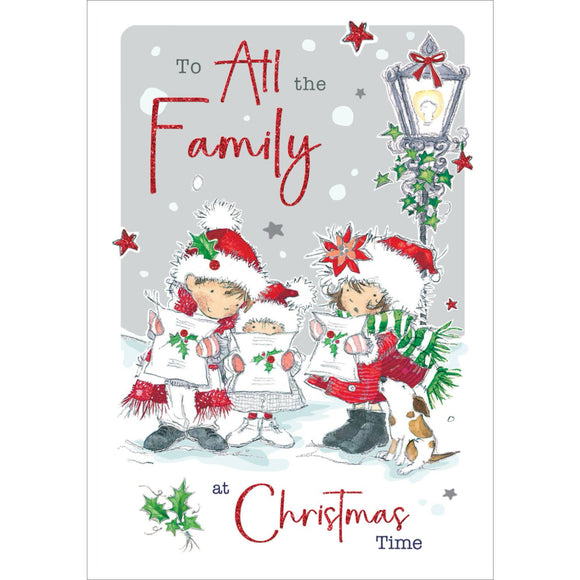 This cute Christmas card for a special family is decorated with a trio of young carol singers dressed in glittery red coats and santa hats. Their puppy joins them in song. Black and glittery red text on the front of this Christmas card reads 