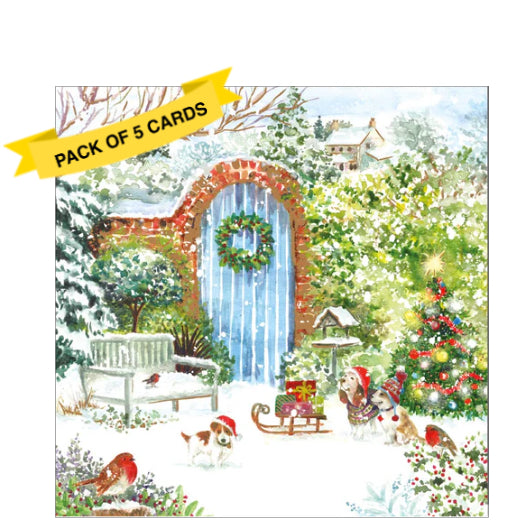 This pack of 5 Charity Christmas cards feature an artwork by Dawn Quigg showing a beautiful well-kept garden, covered with snow. A trio of dogs in hats and jumpers sit beside a decorated christmas tree.