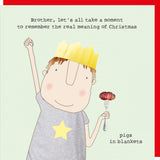 This Christmas card features one of Rosie Made a Thing's unmistakably witty and charming illustrations showing a man wearing a paper crown and holding a pig in a blanket. The caption on the front of the card reads "Brother, let's all take a moment to remember the real meaning of christmas....pigs in blankets".