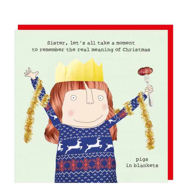 This Christmas card features one of Rosie Made a Thing's unmistakably witty and charming illustrations showing a lady wearing a paper crown holding a pig in a blanket on a fork in one hand and raising the other fist triumphantly. The caption on the front of the card reads 