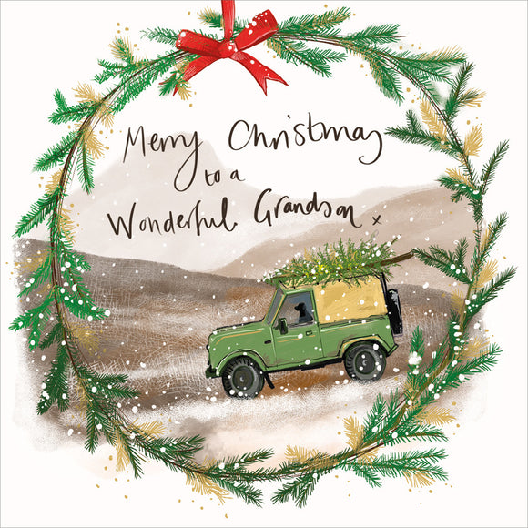 Part of Alex Clark's Christmas card collection, this Christmas card for a special grand-son is decorated with Alex's painting of a  landrover with christmas tree driving over the moor. A Christmas wreath forms a border. The text on the front of the card reads 