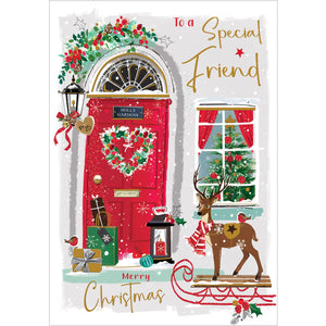 This Jonny Javelin Christmas card for a dear friend features a vibrant image of a red front door adorned with festive garlands and a heart-shaped wreath. A pile of beautifully wrapped gifts can be seen resting on the doorstep. Red and gold text on the front of this Christmas card reads "To a Special Friend...Merry Christmas".