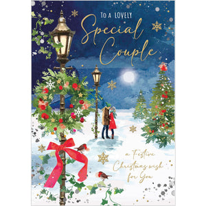 This stunning Jonny Javelin Christmas card&nbsp;for a special couple is decorated scene of a couple, wrapped up warmly against the cold and snow, paused to kiss under a victorian-style streetlamp. Gold text on the front of the card reads "To a lovely Special Couple...a Festive Christmas wish for you".