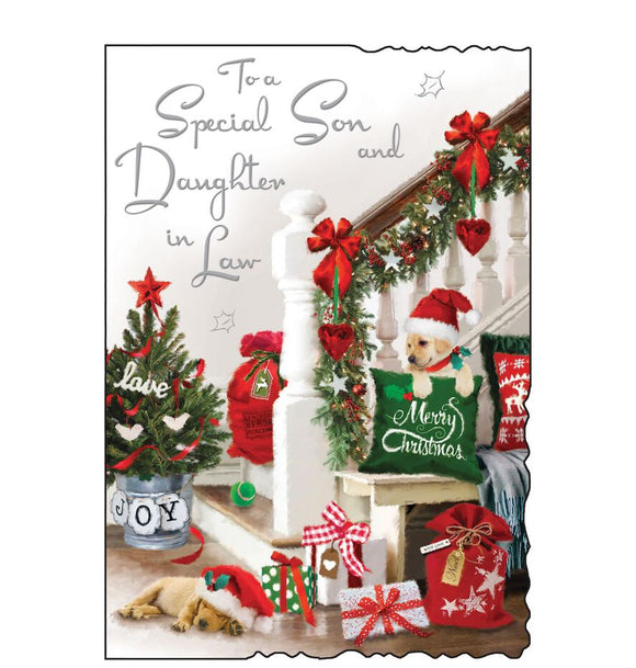This Christmas card for a special son and daughter in law is decorated with a scene of a hallway, decorated for christmas with garlands on the stairs, festive cushions, a tree and a cute little puppy in a santa hat. Silver text on the front of this Christmas card reads 