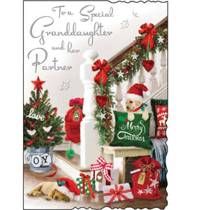 This Christmas card for a special granddaughter and partner is decorated with a scene of a hallway, decorated for christmas with garlands on the stairs, festive cushions, a tree and a cute little puppy in a santa hat. Silver text on the front of this Christmas card reads "To a Special Granddaughter and her Partner". 