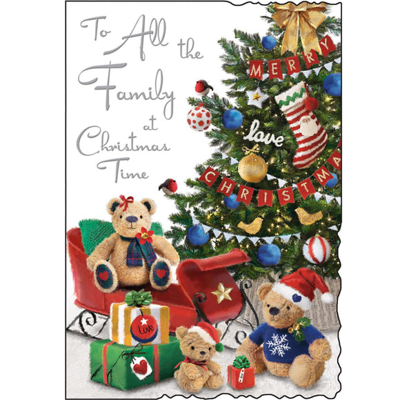 This christmas card for a special family is decorated with an illustration of three teddy bears sitting next to a beautifully adorned Christmas tree. Silver text on the front of this Jonny Javelin Christmas card reads 