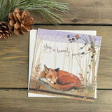 This small christmas card by artist Alex Clark is decorated with an illustration of a red fox curled up asleep on a forest floor. The text on the front of the card reads "sleep in heavenly peace... in a handwriting style font.