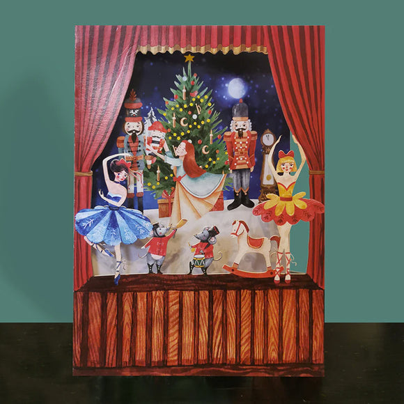 This stunning christmas card has a laser cut scene of a stage performance of the nutcracker ballet. Clara dances around a christmas tree in the background, with lasercut ballerinas and mice in the foreground, giving the scene depth.