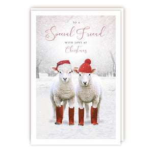 A wonderful country themed Christmas card for a special friend with two sheep in red hats and wellies looking out from a winter landscape. The caption on the front of this Christmas card reads "To a Special Friend with love at Christmas".