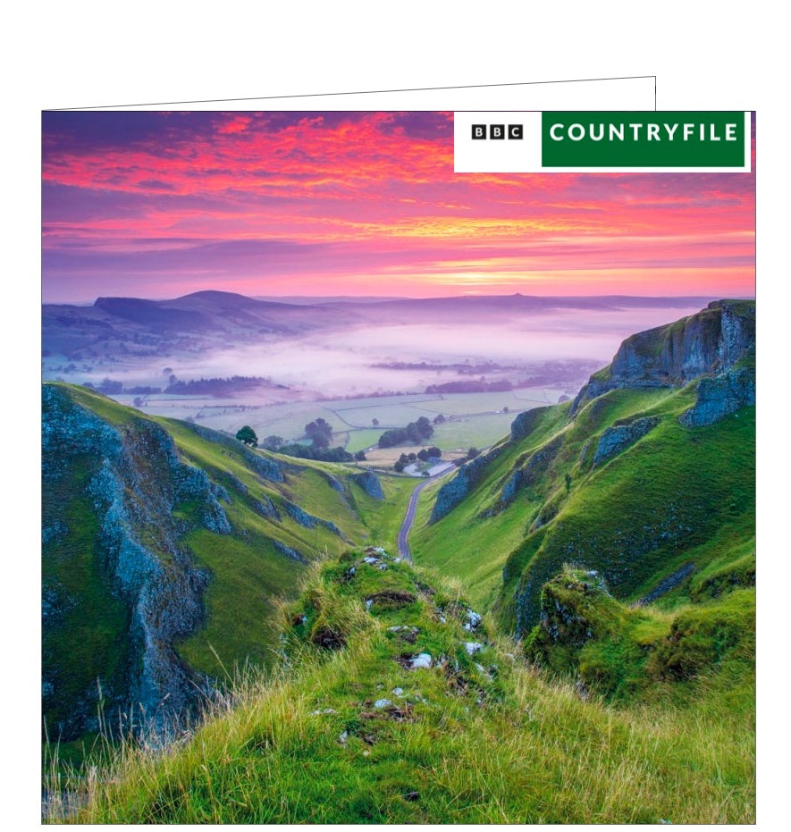 This blank card from the BBC Countryfile range features a photograph by Lee Howdle showing the sun setting in the Winnats Pass in the Derbyshire Peak District National Park.