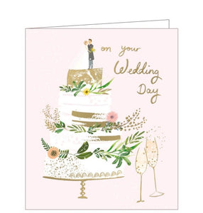 This lovely wedding celebration card is decorated with a gold and white three tiered cake, adorned with foliage, flowers and topped with a bride and groom. Gold text on the front of the card reads "on your Wedding Day".