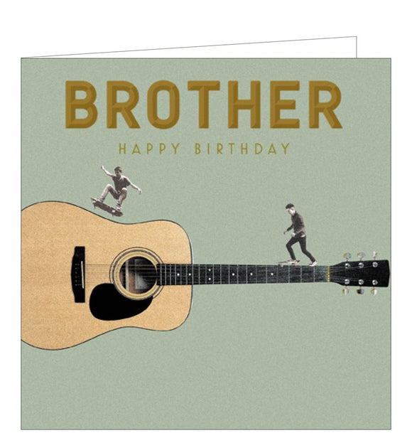 This birthday card for a special brother is decorated with a large guitar spanning the width of the card, while two men ride skateboards over the guitar. Gold text on the front of the card reads 