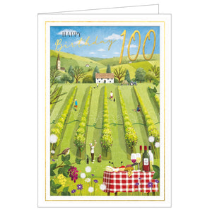 This lovely 100th birthday card is decorated with a scene of a sunny vineyard with a table in the foreground, laid with cheese and wine. Golden text on the front of the card reads "Happy Birthday....100."