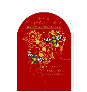 A stunning anniversary card for a special son and daughter in law is decorated with a pair of bees sitting on gold, heart shaped honeycomb. Gold text on the front of the card reads "Son & Daughter-in-Law...Happy Anniversary...you BEE-long together".