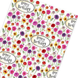 This Alex Clark wrapping paper features a repeating design of red, pink, purple and yellow dahlia flowers, surrounding text that reads "Happy Birthday".