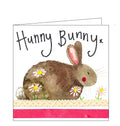 This card is decorated with a cute brown bunny rabbit sitting among daisies. The text on the front of the card reads "Hunny Bunny x".