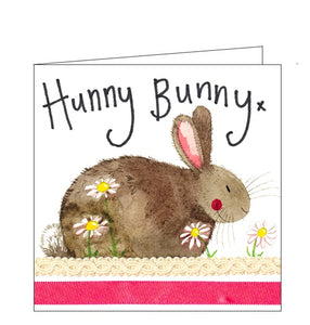 This card is decorated with a cute brown bunny rabbit sitting among daisies. The text on the front of the card reads "Hunny Bunny x".