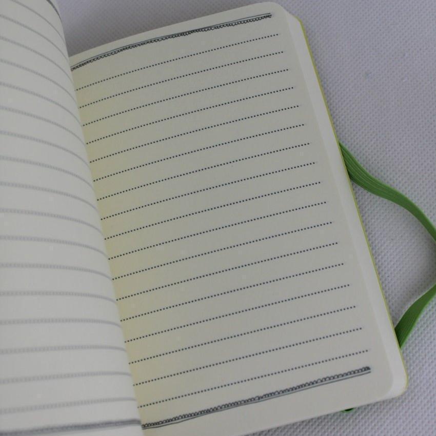 Official Alex Clark illustrated stationery range of an A6 notebook with toffee the cat on the cover, lined pages inside and polka dots on the back. Notebook is secured with an elastic band.