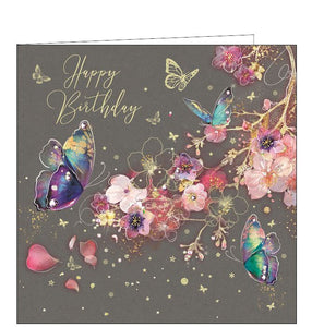 This birthday card is decorated with glittering butterflies and pink blossom flowers. Metallic gold text on the front of the card reads "Happy Birthday".