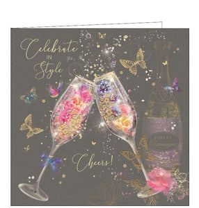 This birthday card is decorated with a pair of champagne flutes, filled with flowers and glittery bubbles. Metallic gold text on the front of the card reads "Celebrate in Style....Cheers!"