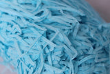 Glick baby blue shredded tissue paper close up
