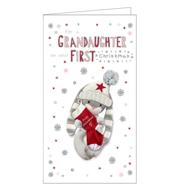 This cute christmas card to commemorate a special grand-daughter's first christmas is decorated with a grey and white knitted rabbit -  wearing a glittery bobble hat - holding a knitted christmas stocking. The caption on the front of the card reads 