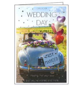 This wedding congratulations card is decorated with a photograph of a bride ands groom driving away in a vintage convertible car, adorned with flowers and balloons. Silver text on the front of the card reads "On your Wedding Day....hoping that your day is all you've wished and more."