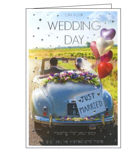 This wedding congratulations card is decorated with a photograph of a bride ands groom driving away in a vintage convertible car, adorned with flowers and balloons. Silver text on the front of the card reads 