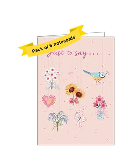 This pack of 6 notelets is decorated with lovely illustrations of different types of flowers and birds. Pink text on the front of the card reads  "Just to Say...". 