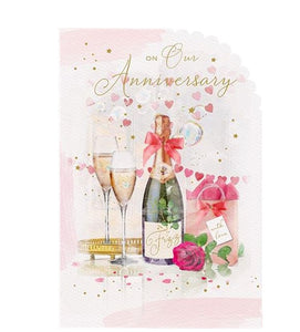 This lovely wedding anniversary card is decorated with an arrangement of flowers and gifts beside a bottle of fizz and two glasses of champagne. Rose-gold text on the front of this anniversary card reads "On Our Anniversary".