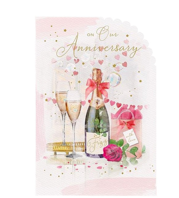 This lovely wedding anniversary card is decorated with an arrangement of flowers and gifts beside a bottle of fizz and two glasses of champagne. Rose-gold text on the front of this anniversary card reads 