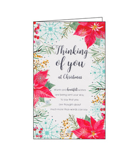Red poinsettia flowers, berries and blue snowflakes decorate the front of this Christmas card. Silver text on the front of the card reads "Thinking of you at Christmas....Warm and heartfelt wishes are being sent your way, to say that you are thought about much more than words can say."