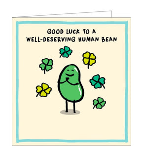 This good luck card is decorated with a green cartoon bean surrounded by four-leafed clovers. The text on the front of the card reads "good luck to a well-deserving Human bean"