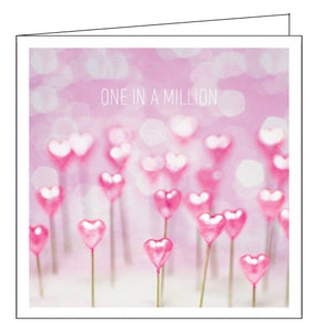 This cute and romantic greetings card is decorated with a photograph of rows of pink heartshaped pins. Text on the front of the card reads "One in a million".