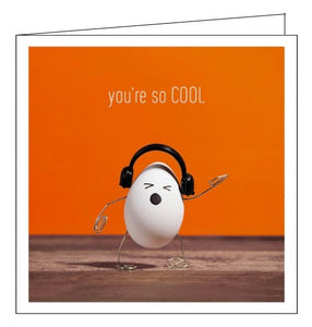 This cute and quirky greetings card is sure to brighten anyone's day. The card is decorated with a photograph of an egg - with paperclip arms and legs wearing a pair of tiny headphones and rocking out. Text on the front of the card reads "you're so COOL".