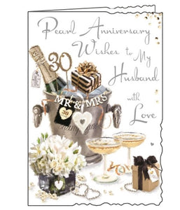 Jonny Javelin greetings cards combine detailed illustrations with heartfelt messages. This 30th Anniversary card for a special husband is illustrated with a table set with champagne and gifts. The text on the front of the card reads "Pearl Anniversary Wishes to my Husband with love".