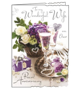 Jonny Javelin greetings cards combine detailed illustrations with heartfelt messages. This 30th Anniversary card for a special wife is illustrated with a table set with champagne and flowers. The text on the front of the card reads "To my wonderful Wife on Our Pearl Anniversary".