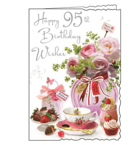 Jonny Javelin cards combine beautiful, detailed illustrations with heartfelt words. This 95th birthday card shows a beautiful pink vase of glittery roses, surrounded by a delicate tea set, cakes and delicious treats. Silver metallic text on the front of the card reads "Happy 95th Birthday Wishes".