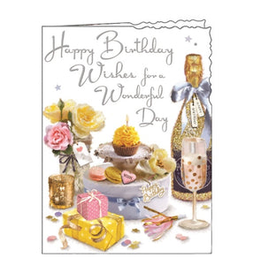 This birthday card is illustrated with a table set with pastel-coloured roses, dainty cakes and a bottle of glittering champagne. The text on the front of the card reads "Happy Birthday Wishes for a Wonderful Day".