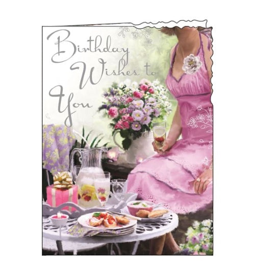 This birthday card is decorated with a table laden with delicate pink cakes and flowers. The text on the front of this Birthday card reads 