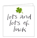 This good luck card is decorated with an embossed metallic green four leaf clover above black brush script text that reads "lots and lots of luck".