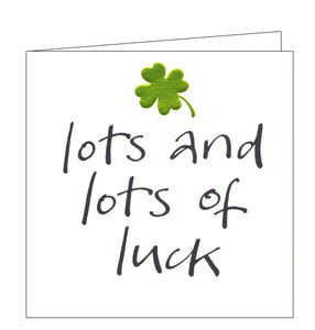 This good luck card is decorated with an embossed metallic green four leaf clover above black brush script text that reads "lots and lots of luck".