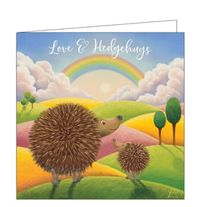 This lovely card features detail from an original pastel drawing by Lucy Pittaway showing two hedgehogs walking through fields towards a rainbow. The text on the front of the card reads "Love & Hedgehugs".
