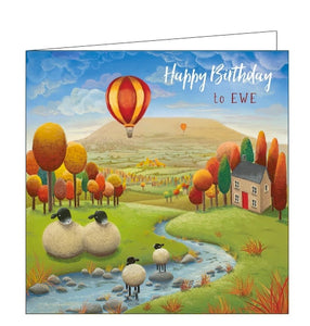 This birthday card features detail from an original pastel drawing by Lucy Pittaway showing a family of sheep crossing a river. In the background the trees change to autumn colours and two hot air balloons rise into the sky above Ingleborough. The text on the front of the card reads "Happy Birthday to ewe".